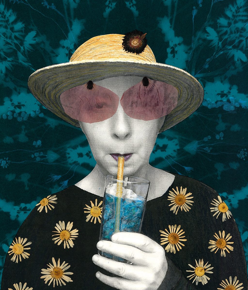 Eine Frau mit Strohhut und Sonnenbrille hält einen Drink in der Hand.